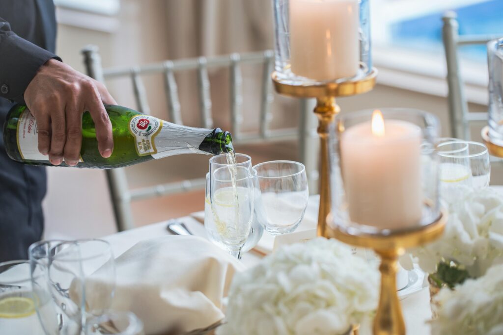 Wedding server pours champagne
